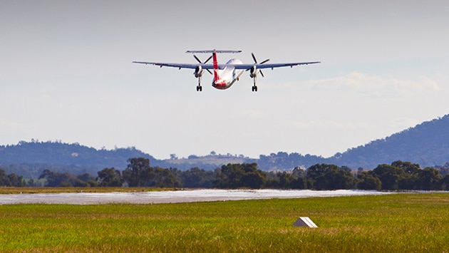 plane in air above runway