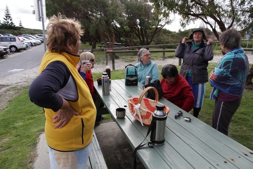 Elderly surfers enjoying a cup of tea