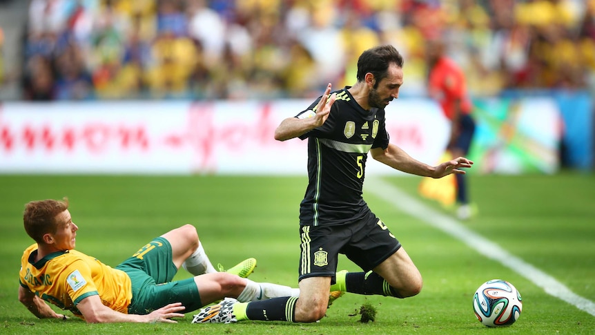 Oliver Bozanic of Australia challenges Juanfran of Spain