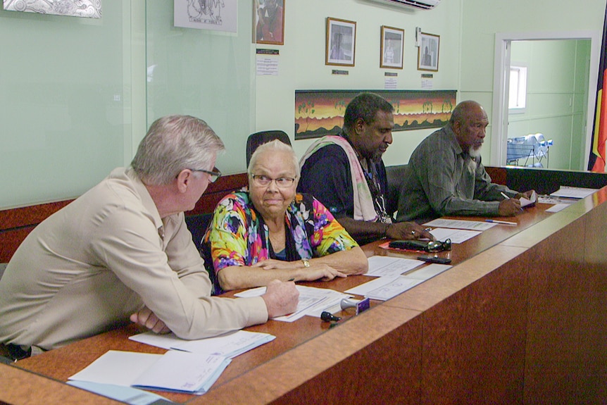 Registrar Ian Clarke, and elders Lillian Gray, Jack Day and Cyril Bligh sit at the Cherbourg court bench.