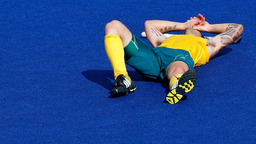 Kieran Govers lies on the pitch after their 4-2 loss to Germany in the men's semi-final hockey.
