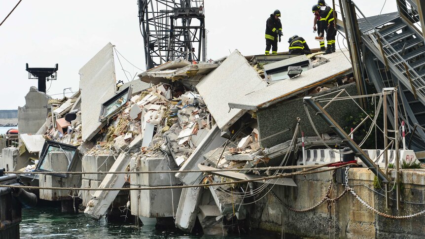Firefighters look for survivors in the rubble left after the Jolly Nero crashed in genoa