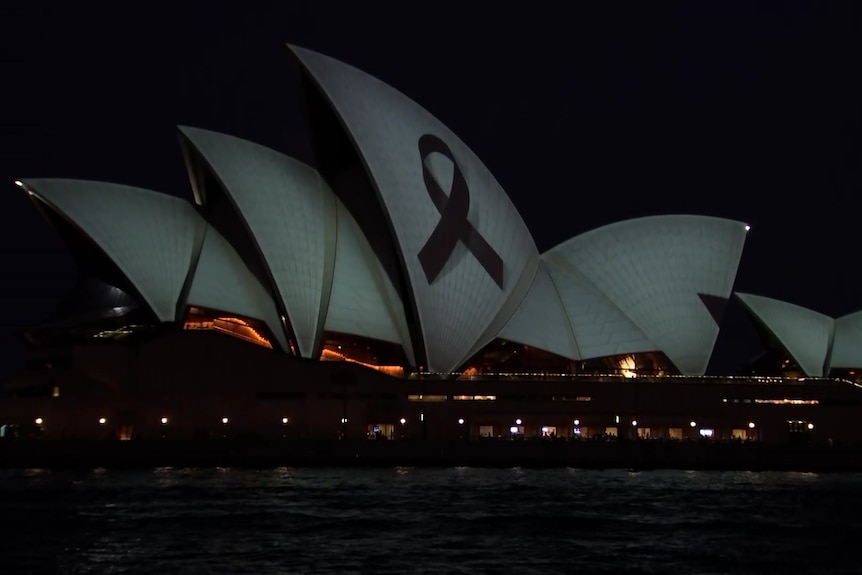Sydney Opera House sails with a ribbon projected onto the centre 