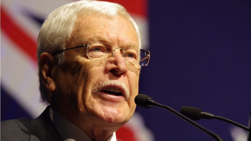 Close-up of WA Liberal Party state president Norman Moore in front of microphones