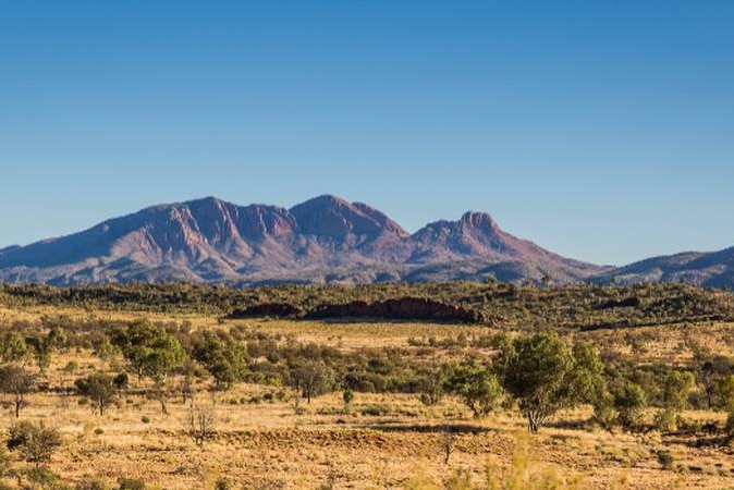 A view of the arid landscape with Mount Sonder on the horizon.