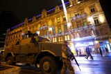 A Belgian soldier patrols near an armoured vehicle in central Brussels