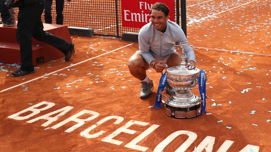 Spain's Rafael Nadal celebrates with the trophy after winning the 2018 Barcelona Open final.