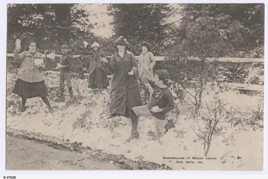 people throwing snowballs in an old black and white photograph