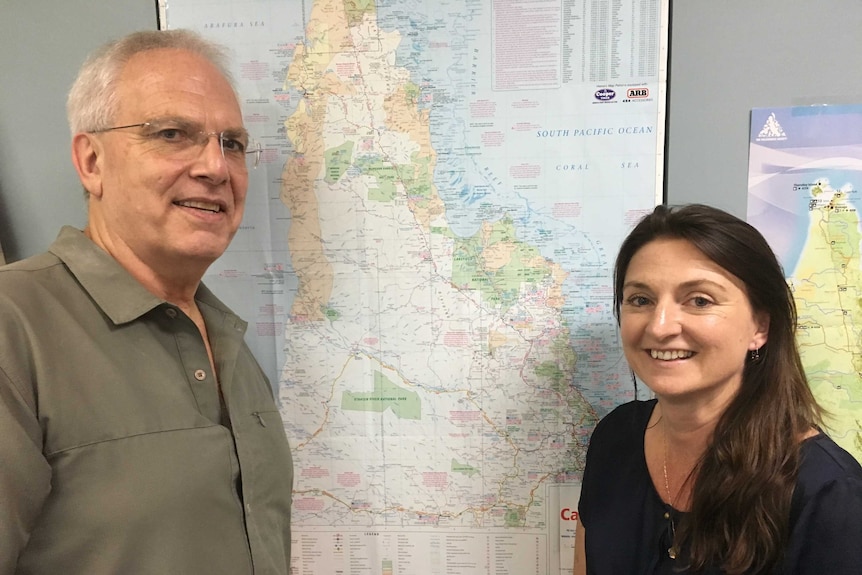 A man and a woman stand in front of a map of Cape York Peninsula.