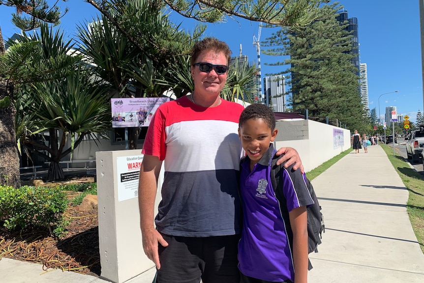 Broadbeach State School student Keanu Schaffer outside school with his dad.