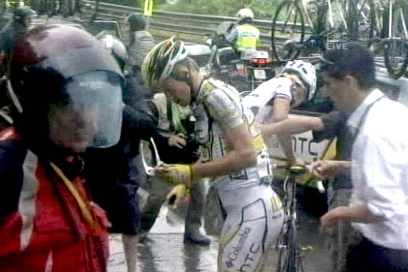 Australian rider Michael Rogers, riding for the Columbia team, gets assistance after crashing