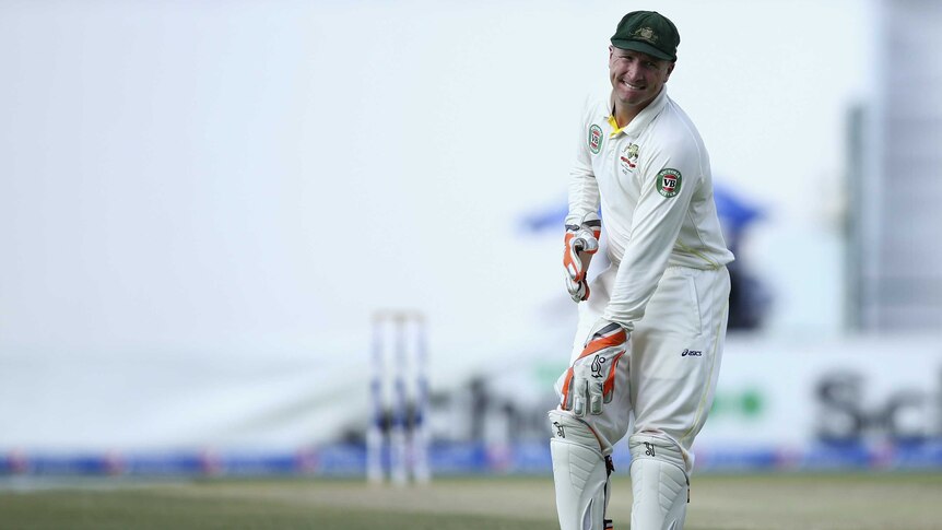 Fighting on ... Brad Haddin shows discomfort from a shoulder injury during day two