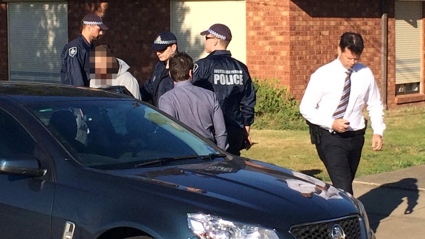 Man placed in police car