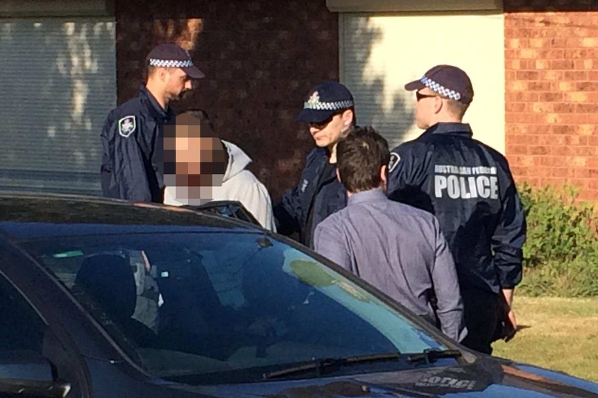 Man placed in police car