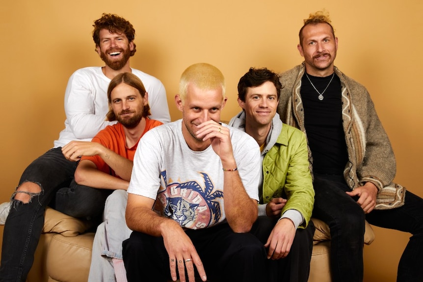 Five men smile into the camera