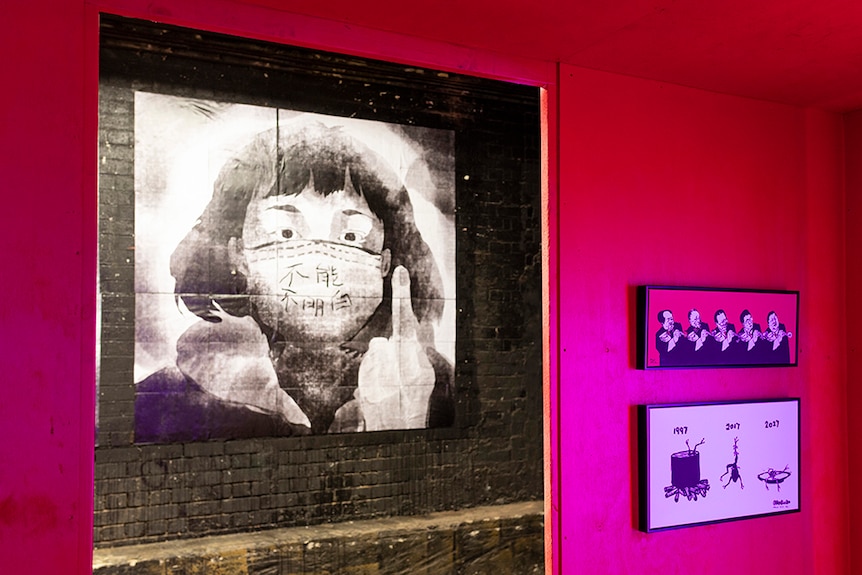 Through the door way of a red gallery space, a girl wearing a face mask raises her middle finger in illustrated artwork.