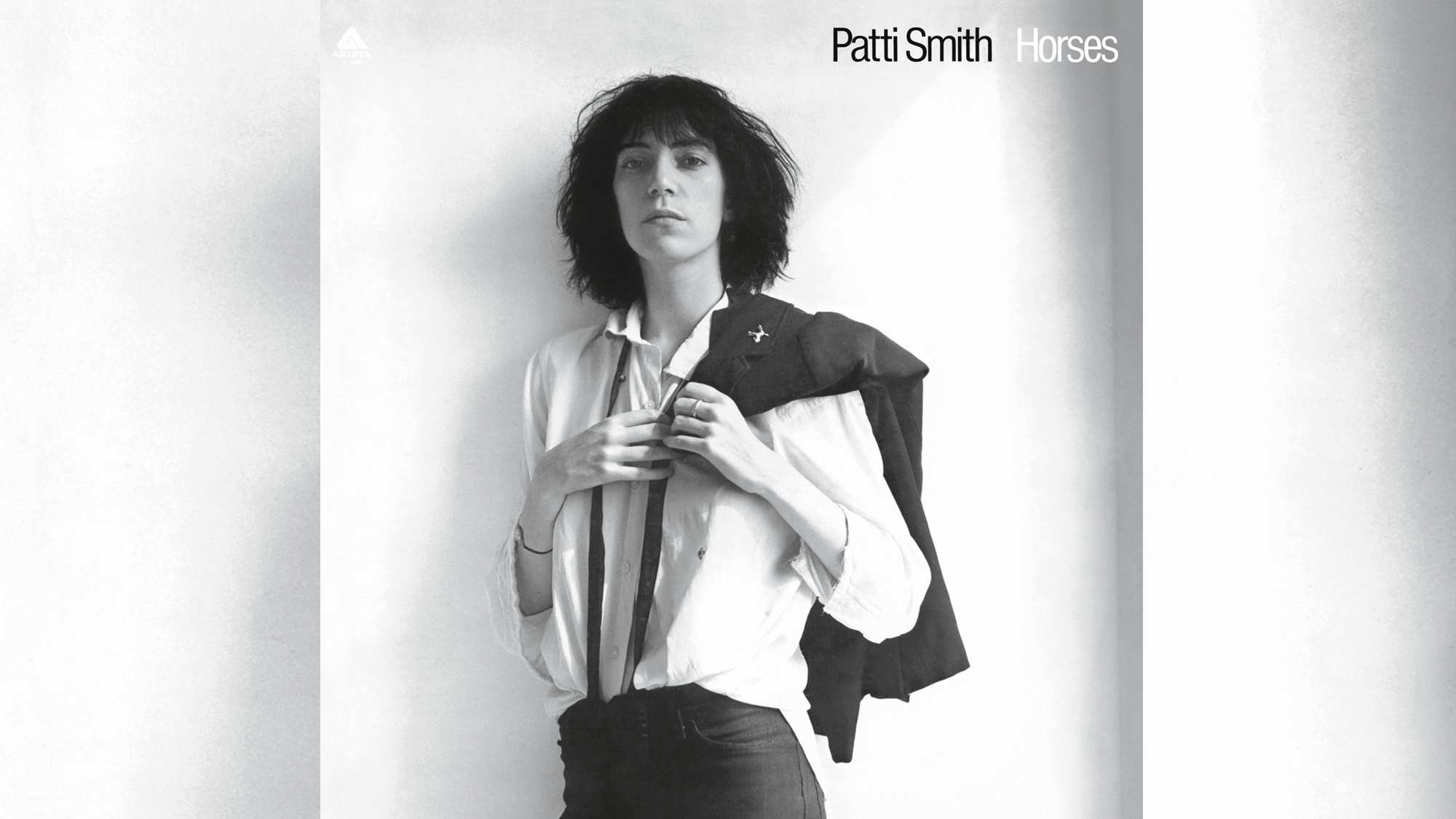 The cover of Patti Smith's Horses, showing Patti holding a jacket over her shoulder