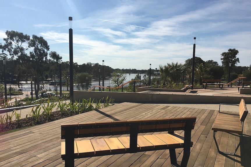 View of Murray River from chairs on a deck, part of tiered steps and ramps.