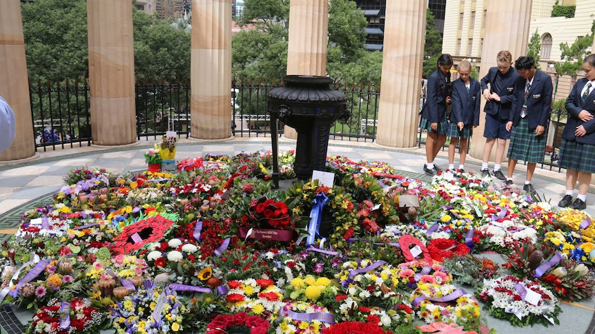 Dozens of wreaths were laid at the bas of the square's Eternal Flame, in Brisbane's CBD