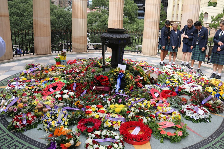 Dozens of wreaths were laid at the bas of the square's Eternal Flame, in Brisbane's CBD