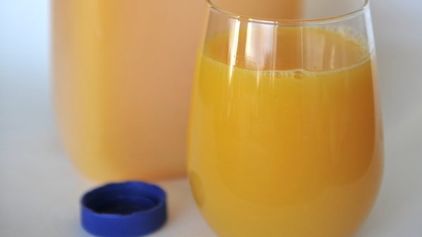 five different large bottles of orange juice