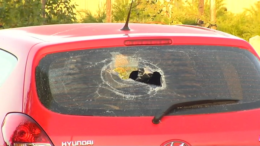 A car rear window is smashed during a wild party in Werribee.