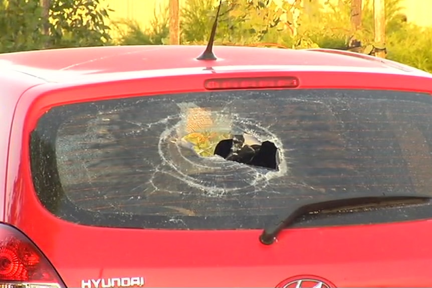 A car rear window is smashed during a wild party in Werribee.