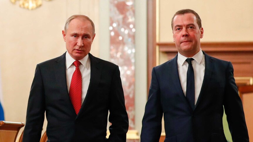 Russian Prime Minister Dmitry Medvedev walking beside President Vladimir Putin