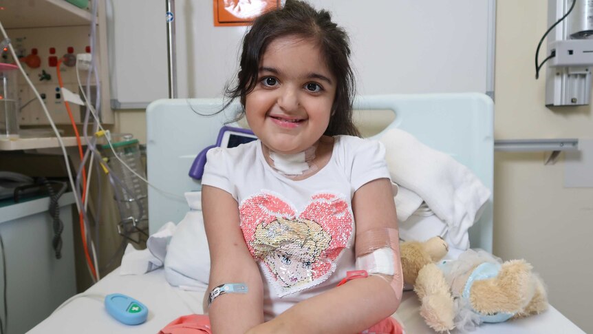 Alisha Kapoor sits in a hospital bed
