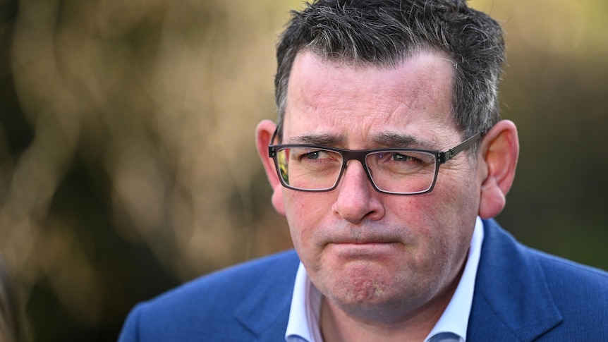 Premier Daniel Andrews purses his lips during a press conference about the Commonwealth Games. The photo is a tight headshot