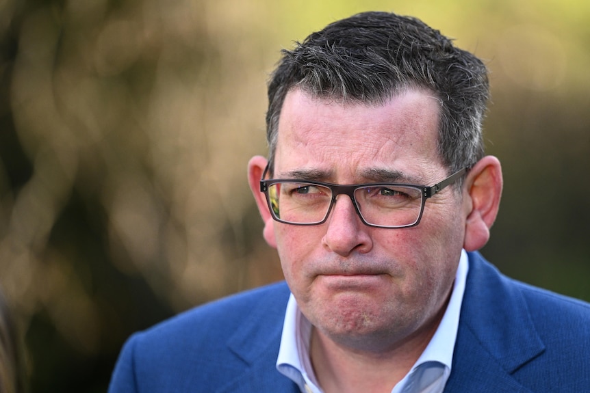 A close up shot of Daniel Andrews face during a media conference.