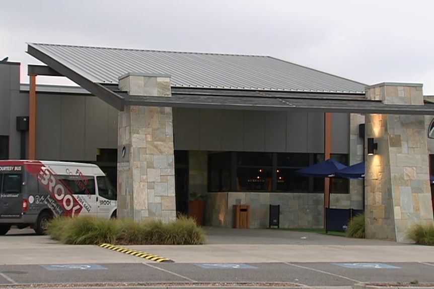 The exterior of a architecturally contemporary hotel under grey morning skies.