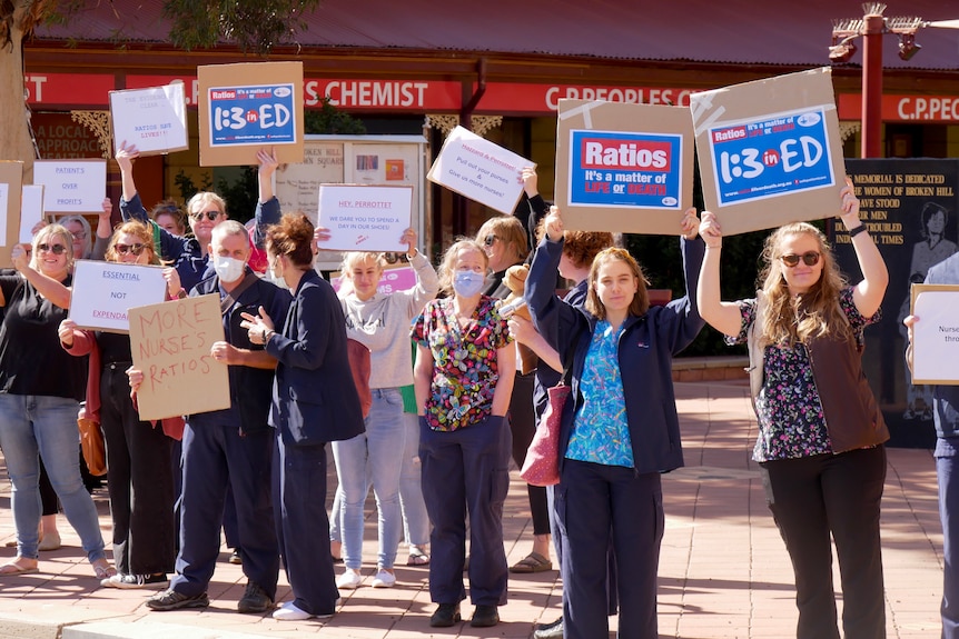 A group of nurses holding signs saying 1:3 in ED on strike in Broken Hill, March 2022. 