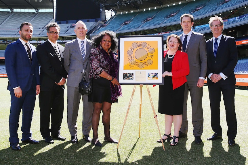Natalie Hutchins and Fiona Clarke with the Indigenous painting at the MCG