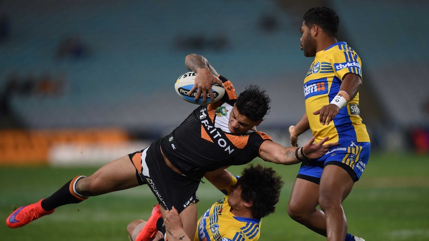 Delouise Hoeter (left) of the Tigers is tackled by Bradley Takajrangi