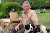 Latrobe farmer Andrew Craigie sits with his dog Sue