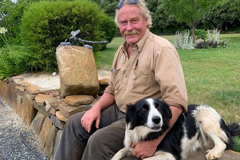 Latrobe farmer Andrew Craigie sits with his dog Sue