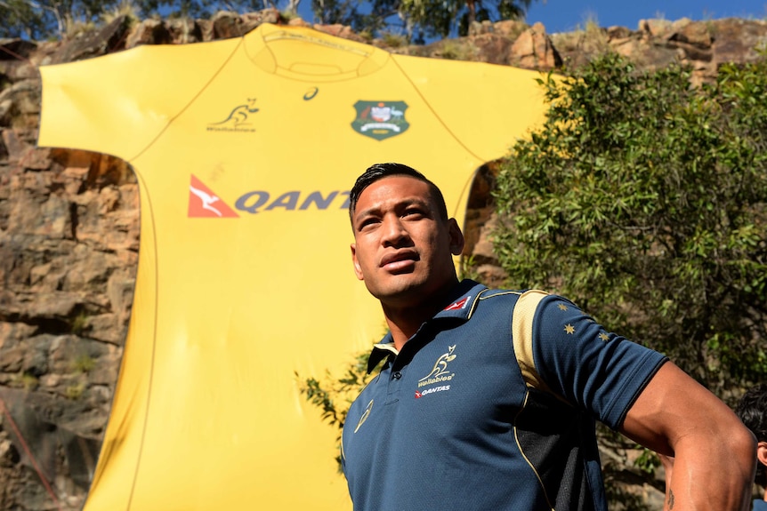 Folau poses in front of a large Wallabies jersey