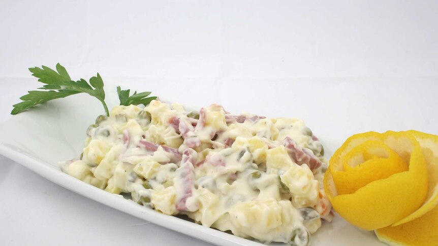 Pasta salad with mayonnaise on a white plate.