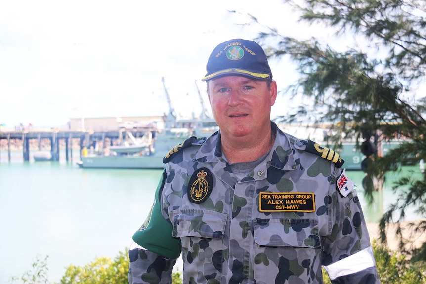 Australian Navy Commander Alex Hawes standing outside.