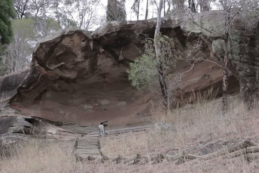 A staircase in the bush leads to ancient caves with Aboriginal paintings.