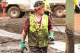 Mud-covered volunteer helps with the Fairfield flood clean-up