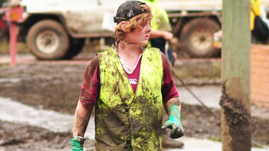 A mud-covered volunteer helps with the flood clean-up in the Brisbane suburb of Fairfield on January 15, 2011.