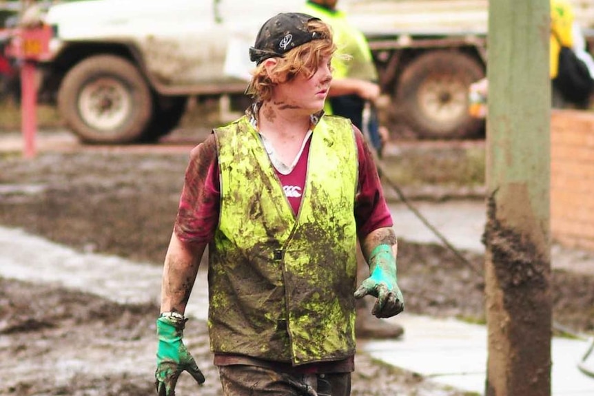 A mud-covered volunteer helps with the flood clean-up in the Brisbane suburb of Fairfield on January 15, 2011.