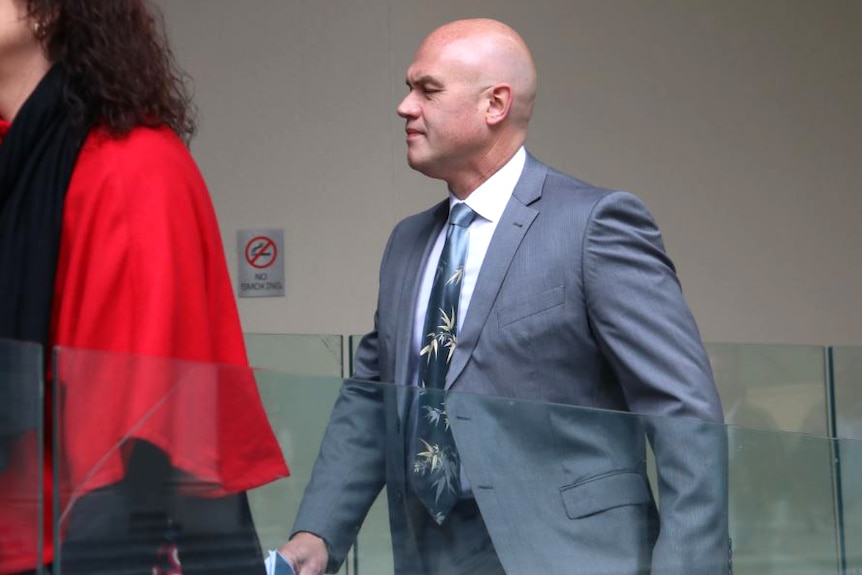 Former parliamentary deputy clerk Nigel Lake enters a Perth courtroom with an unknown woman.