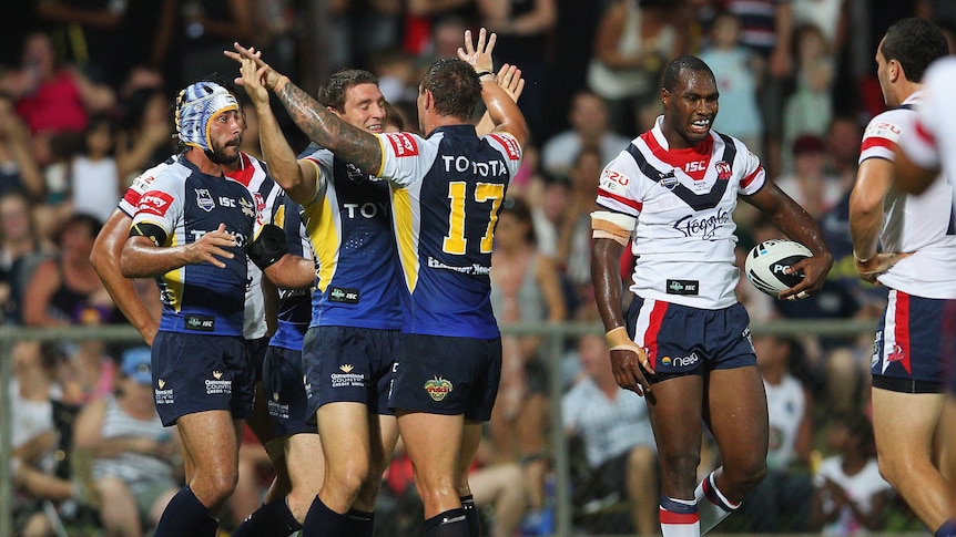 Ride 'em Cowboys ... Ashley Graham and his team-mates celebrate one of nine tries against the Roosters.