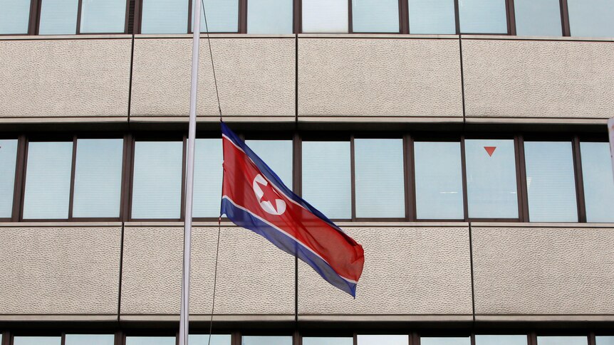 A North Korean flag flies at half mast in front of the Chongryon