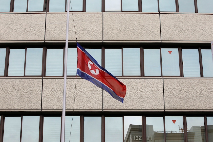 A North Korean flag flies at half mast in front of the Chongryon