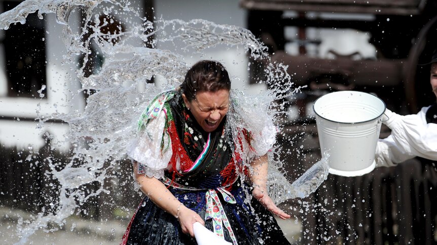 A Hungarian girl is soaked by local boys during 'watering of girls' fertility ritual.