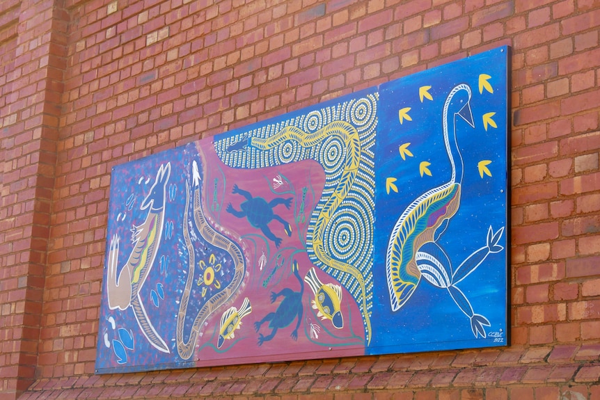 An indigenous mural on a brick wall at the Broken Hill Correctional Centre. 